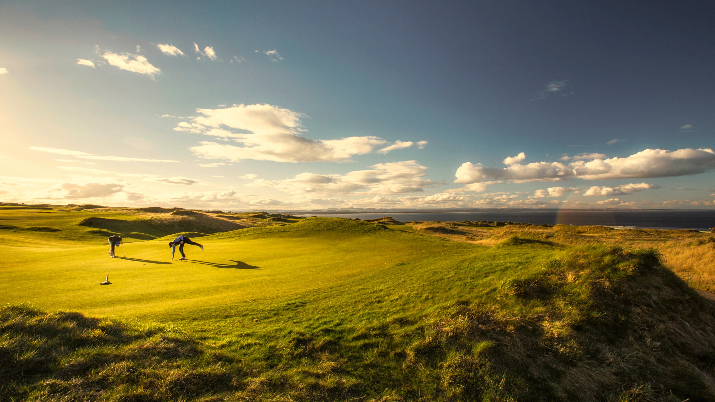 Golfers on a lovely golf course in St. Andrews, Scotland Golfers on a lovely golf course in st. andrews, scotland